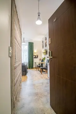 a room with a hallway with a living room at Green - Apartamenty Kleparskie in Kraków