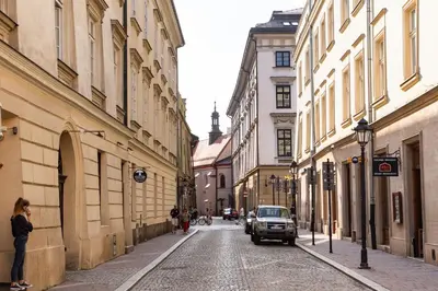 a city street with buildings and a truck parked on the street at St Thomas Residence Old Town in Kraków