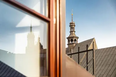 a view from a window of a building with a tower at St Thomas Residence Old Town in Kraków