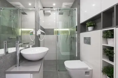 a bathroom with a sink and a toilet and a shower at Horizon Apartments - Krowoderska in Kraków