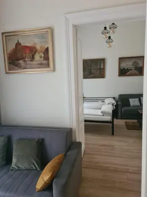 a living room with a couch and a painting on the wall at AMBER APARTAMENt 11 in Kraków