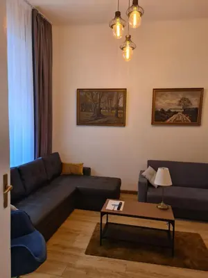 a living room with a blue couch and a table at AMBER APARTAMENt 11 in Kraków