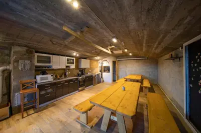 a kitchen with two wooden tables in a room at Gorczańskie Siedlisko in Ochotnica Górna