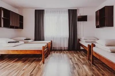 a room with two beds and a window at Dom Wypoczynkowy U STASKA in Ochotnica Dolna