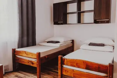 two twin beds in a room with a window at Dom Wypoczynkowy U STASKA in Ochotnica Dolna