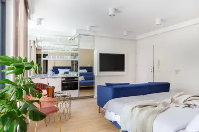 a room with a painting of fish on the wall at Fragola Apartments Vistula View in Kraków