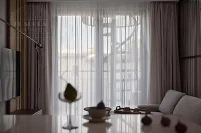 a dining room with a table and a large window at Fragola Apartments Vistula View in Kraków