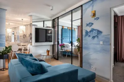 a bed in a room with a large window at Fragola Apartments Vistula View in Kraków