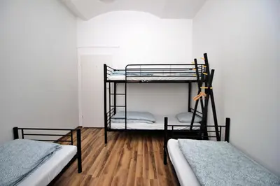 two bunk beds in a room with wooden floors at Hostel Cinnamon in Kraków