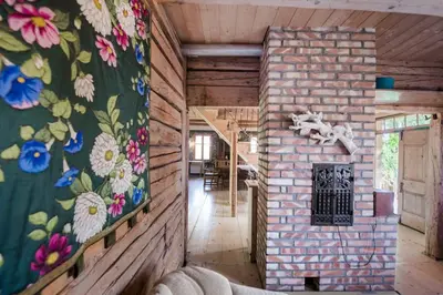 a room with a brick wall with flowers on it at Domek nad Galerią in Lanckorona
