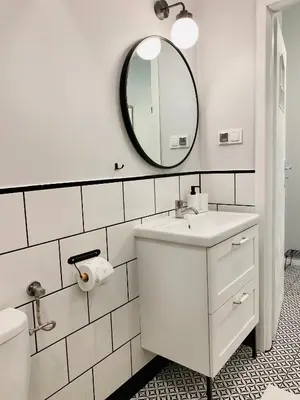 a white bathroom with a sink and a mirror at Cozy Apartment in the heart of Jewish District in Kraków
