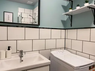 a white bathroom with a sink and a toilet at Cozy Apartment in the heart of Jewish District in Kraków