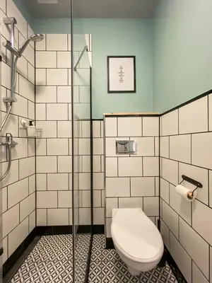 a bathroom with a toilet and a glass shower at Cozy Apartment in the heart of Jewish District in Kraków