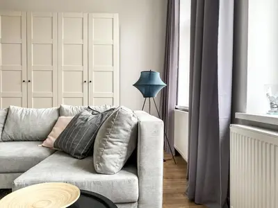 a living room with a couch and a lamp at Cozy Apartment in the heart of Jewish District in Kraków