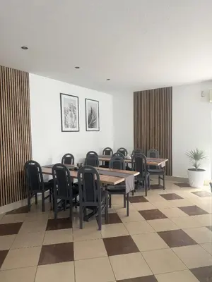 a dining room with wooden tables and chairs at Kompleks Rekreacyjno-Wypoczynkowy i Restauracja STRUMYK in Jordanów