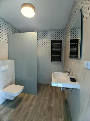 a bathroom with a sink and a toilet at Apartament A2D Kraków in Kraków