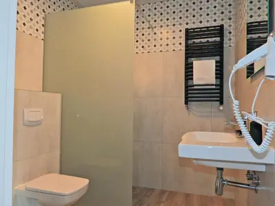 a bathroom with a toilet and a sink at Apartament A2D Kraków in Kraków