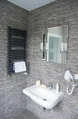 a bathroom with a sink and a mirror at Apartament A2D Kraków in Kraków