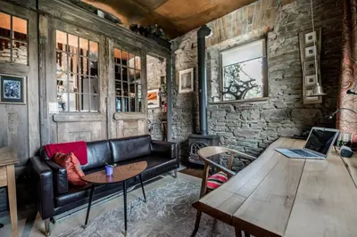 a living room with a leather couch and a table at Mała Kuźnia in Lanckorona