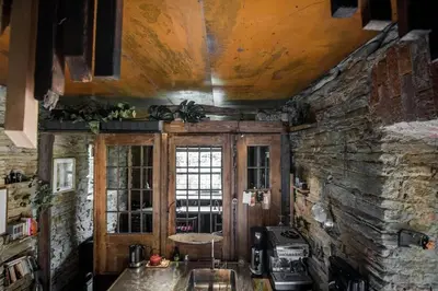 a room with a stone wall and a window at Mała Kuźnia in Lanckorona