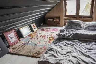 a bedroom with two beds and a rug at Mała Kuźnia in Lanckorona