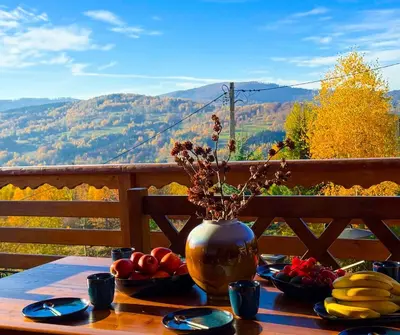 a table with a vase on it with fruit on it at Rezydencja Zawoja in Zawoja