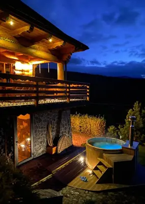 a backyard with a hot tub and a house at Rezydencja Zawoja in Zawoja