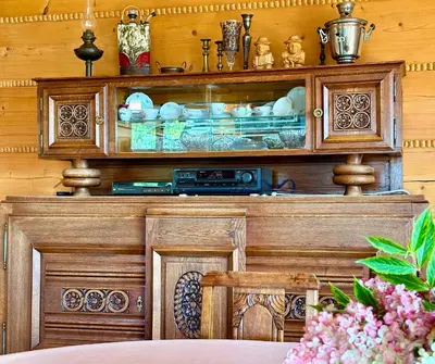 a wooden cabinet in a room with a table at Rezydencja Zawoja in Zawoja