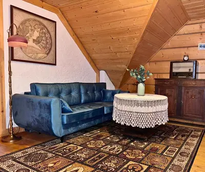 a blue couch in a living room with a table at Rezydencja Zawoja in Zawoja
