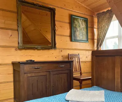 a bedroom with a bed and a mirror on the wall at Rezydencja Zawoja in Zawoja