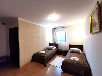 a small room with two beds and a couch at Dworek Złoty Róg Hotel i Restauracja in Kraków