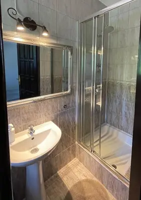 a bathroom with a sink and a shower at Dworek Złoty Róg Hotel i Restauracja in Kraków