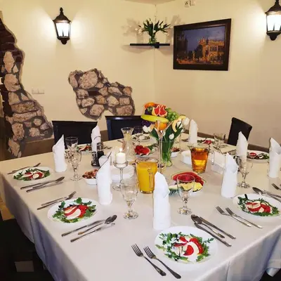 a white table with plates of food on it at Dworek Złoty Róg Hotel i Restauracja in Kraków