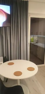 a white table in a room with a kitchen at Apartamenty na Wzgórzu in Bochnia