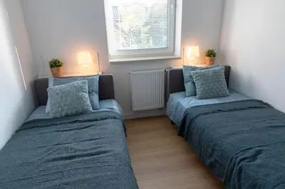 two beds in a small room with two pillows at Apartamenty na Wzgórzu in Bochnia