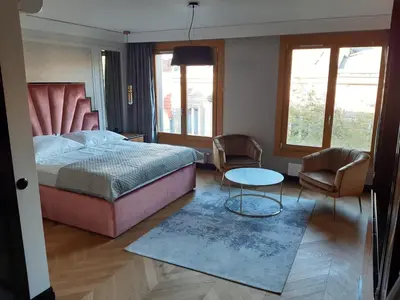 a bedroom with a bed and a table and chairs at KR47 Kossak Residence in Kraków