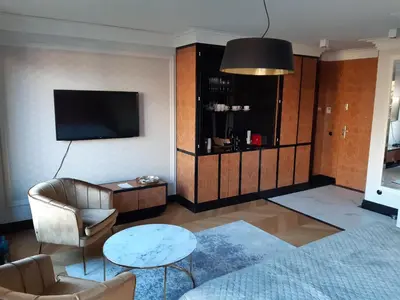 a living room with a tv and a couch and a table at KR47 Kossak Residence in Kraków