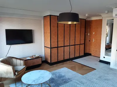 a living room with a couch a table and a tv at KR47 Kossak Residence in Kraków
