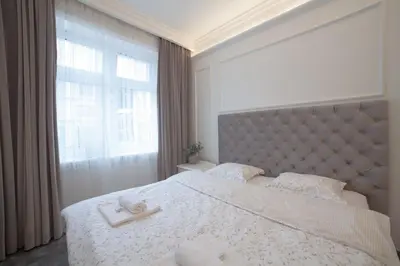 a bedroom with a large bed with a large window at Boleslav Home De Luxe in Sucha Beskidzka