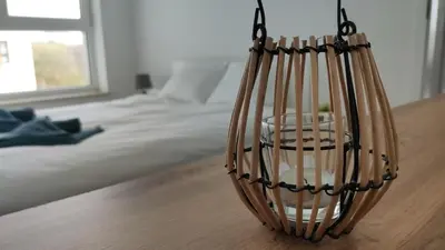 a bedroom with a bed and a basket on the floor at Dąbska 26 by Homeprime in Kraków