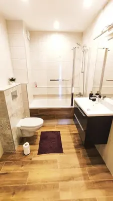 a bathroom with a shower and a toilet and a sink at Dąbska 26 by Homeprime in Kraków