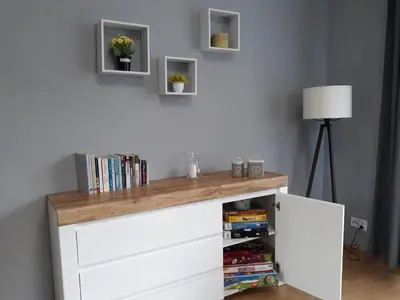 a white cabinet with a wooden counter top at Apartament nad Gorczańskim Strumieniem in Koninki