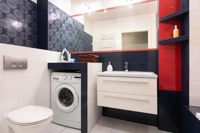 a bathroom with a washing machine and a sink at D&A Apartments Pawia in Kraków