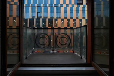 an open window with a view of a building at D&A Apartments Pawia in Kraków