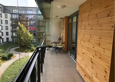 a balcony with a table and chairs in a building at Apartment on the Boulvard in Kraków