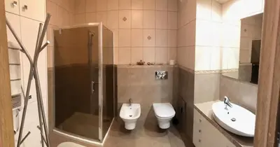 a bathroom with a shower and a toilet and a sink at Apartment on the Boulvard in Kraków