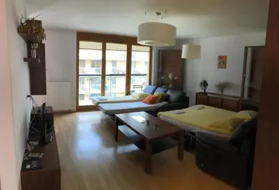 a living room with a couch and a table at Apartment on the Boulvard in Kraków