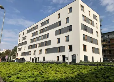 a large white building with a lot of windows at Apartment on the Boulvard in Kraków