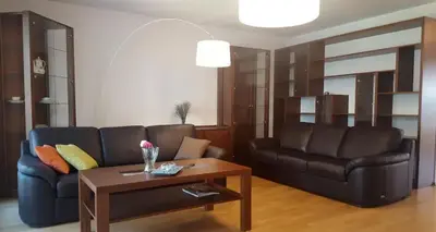 a living room with two leather couches and a coffee table at Apartment on the Boulvard in Kraków