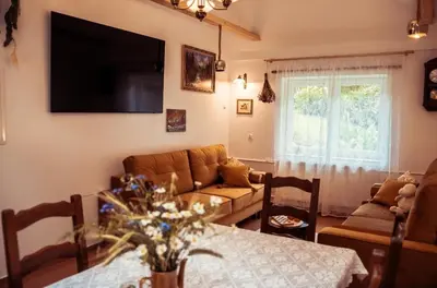 a living room with a couch and a table at Dom Pod Lasem 44 in Klecza Górna